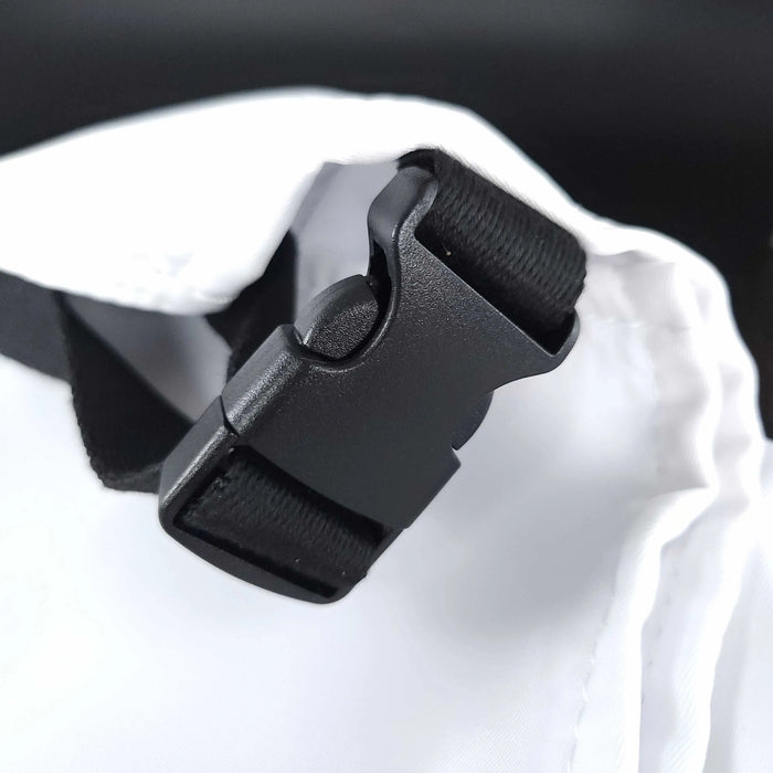 StyleCraft Pro Apron Close-up of a black buckle on a white bag with a blurred background