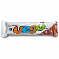 A packaged whole hazelnut chocolate bar from the brand Vego, shown horizontally on a plain white background. The wrapper is primarily white with a large, colorful 'vego' logo in orange, blue, brown, and green, and a photo of whole hazelnuts on the right side.